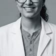 Dr. Jasmeet Kaur, D.D.S., in a white coat at Radiant Smiles.