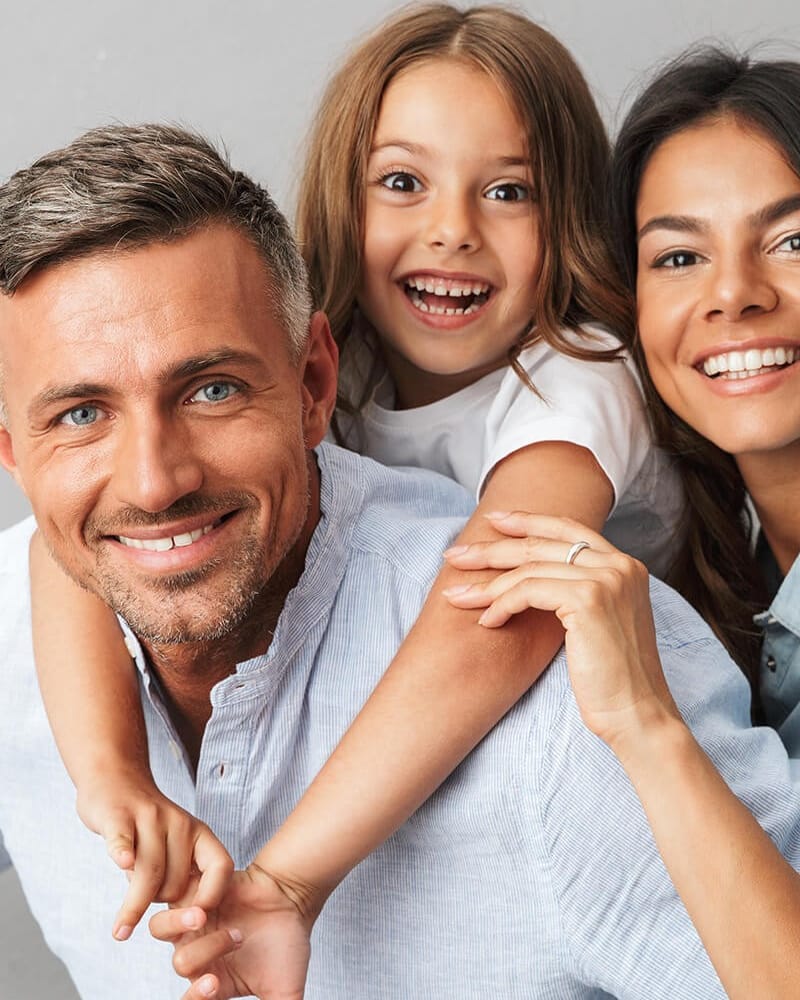 A family smiling together — the subject of Radiant Smiles' family dentistry.