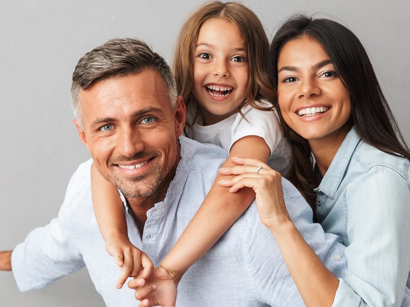 A family smiling together — the subject of Radiant Smiles' family dentistry.